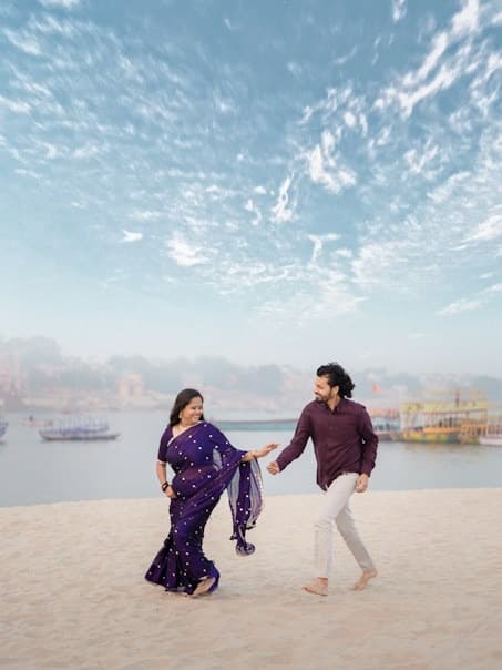 Moments We Celebrate - Indian couple walking along Varanasi riverbank