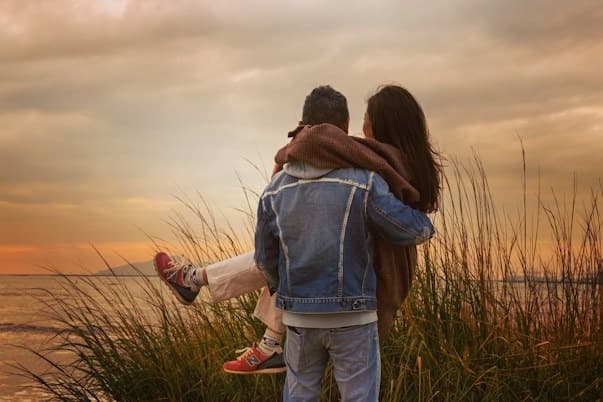 People We Love - Romantic couple embracing in golden hour sunset